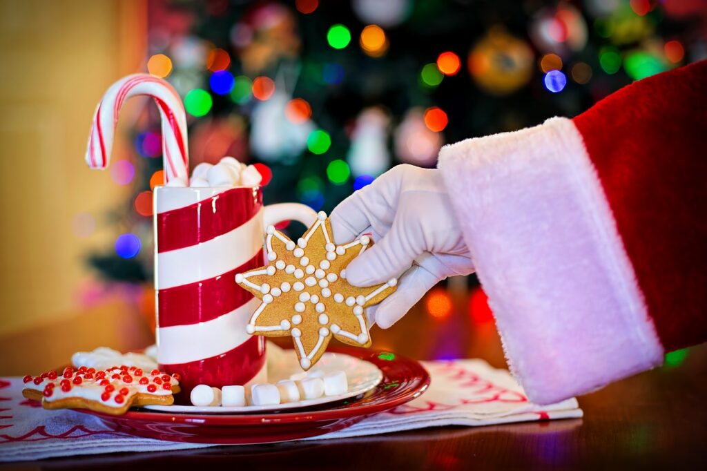 Weihnachtsmann nimmt sich einen Keks vom Weihnachtsteller